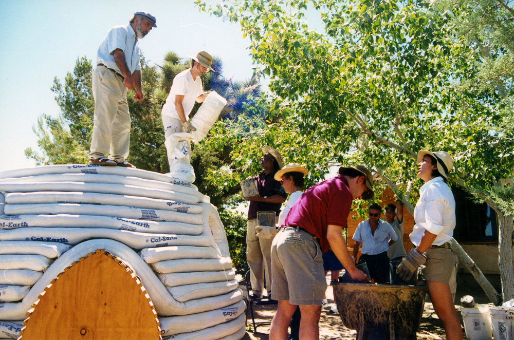 Nader Khalili working with officials from UNHCR on disaster relief housing. Photo via Cal-Earth