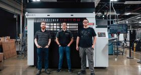 The JuggerBot 3D team alongside the Tradesman Series P3-44 system, a key component in the AFRL-funded hybrid additive manufacturing project. Photo via JuggerBot 3D.