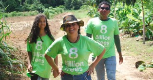 Three 8 Billion Trees team members smiling and walking alongside a tree planting site in a remote tree location deep in the Amazon Rainforest(Tocantins Region) after completing the mission of planting native species saplings during a forestry project aimed at reducing greenhouse gases