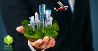 A business man in a suite holding a segment of earth with buildings on it and a plane flying away.