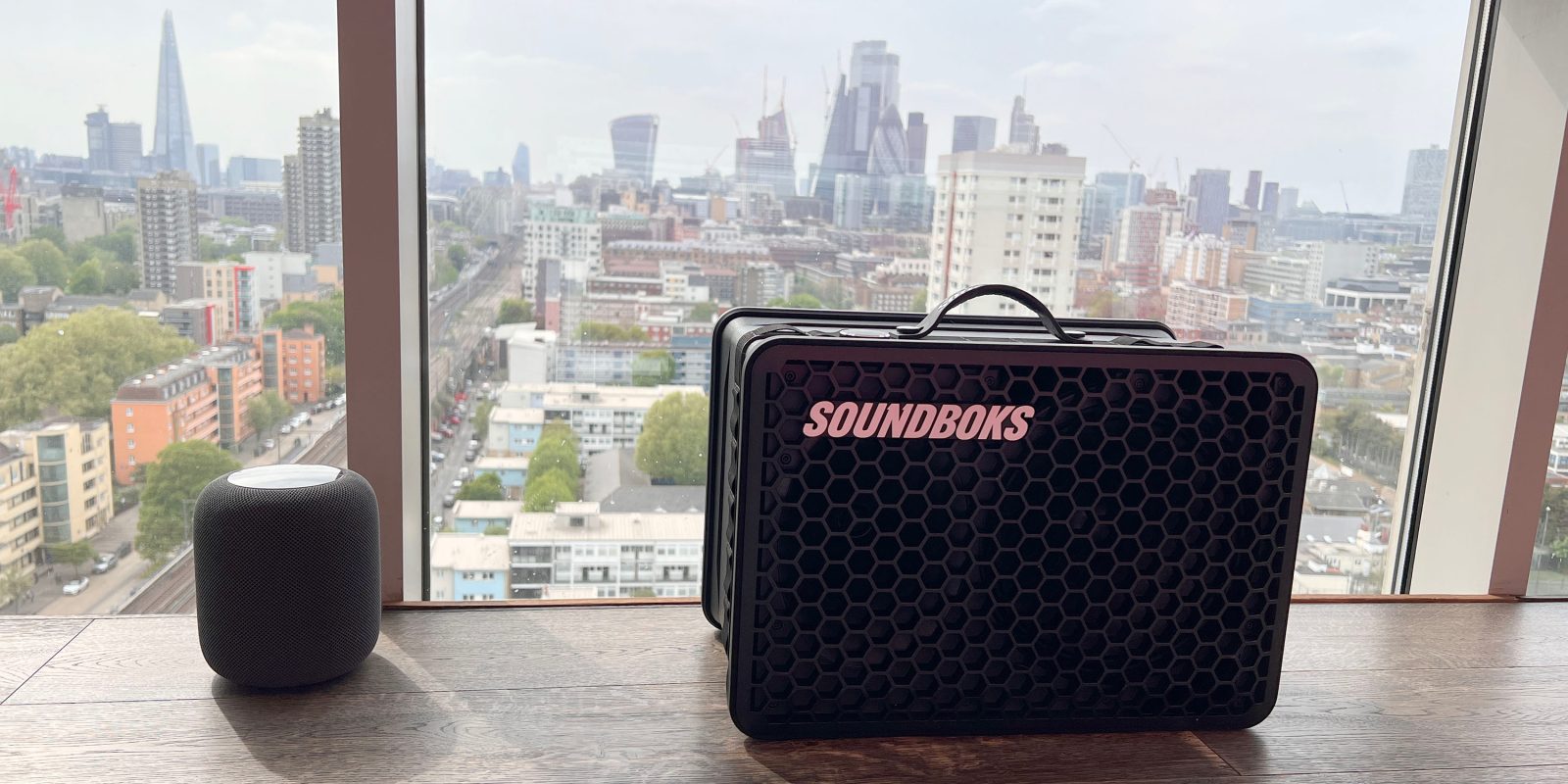 Soundboks Go shown next to a HomePod