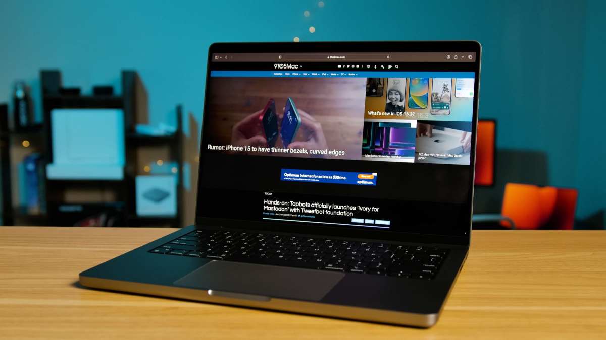 a laptop computer sitting on top of a wooden table