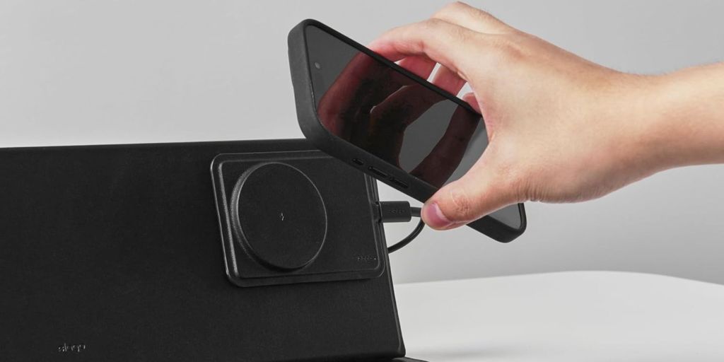 Image showing a person attaching an iPhone to elago's 15W wireless charger.