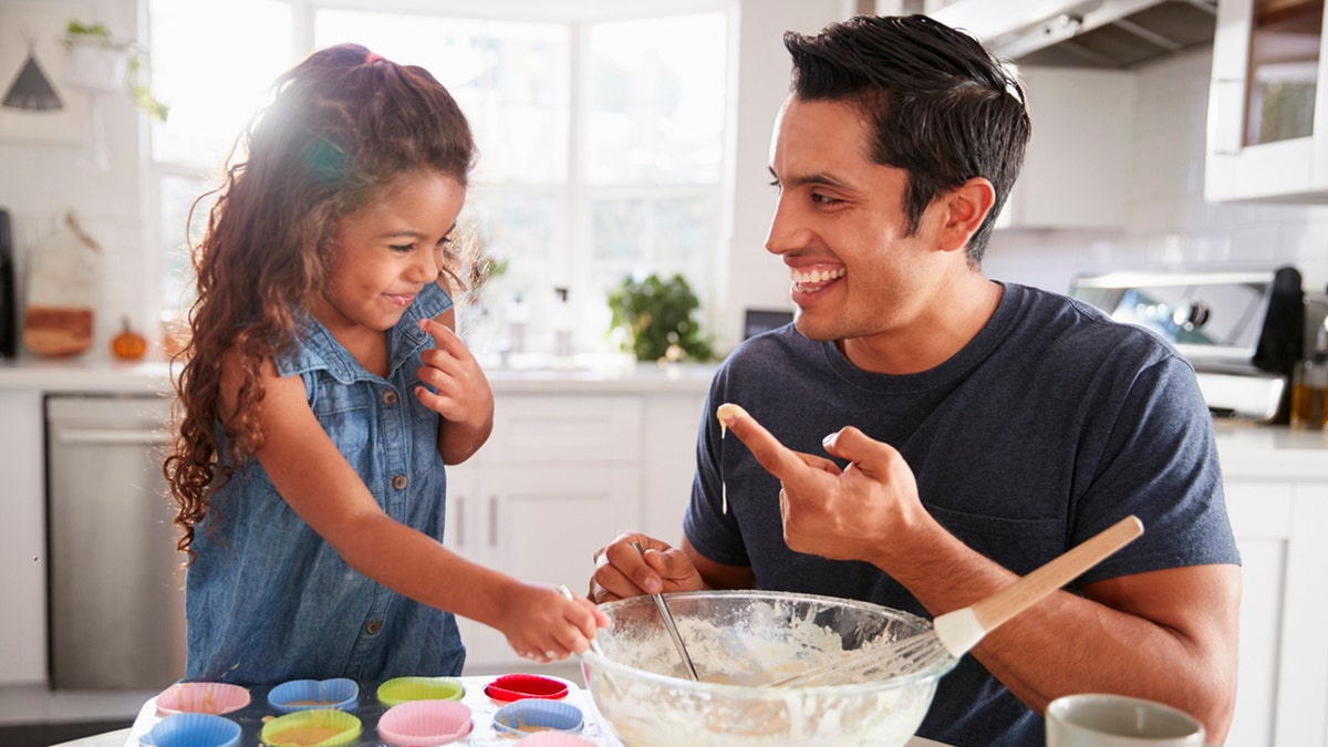 cracking egg trend father in the kitchen with child