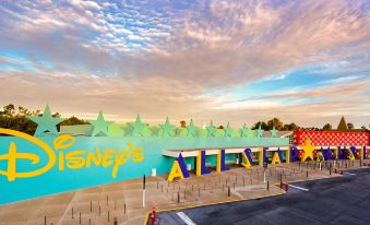 "a large , modern movie theater with a sign that says "" disney 's all - star "" in front of it" at Disney's All-Star Music Resort