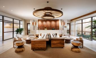 a luxurious living room with wooden furniture , including a couch , chairs , and a coffee table at Fairmont Mayakoba