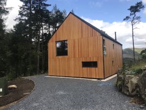 Red Stag with Stunning Loch and Waterfall View