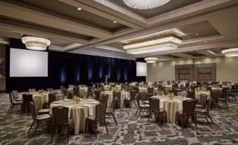 a large , empty banquet hall with multiple dining tables and chairs set up for a formal event at Grand Hyatt Vail