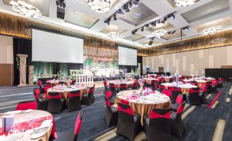 a large conference room with multiple round tables and chairs , set up for an event at Racv Royal Pines Resort Gold Coast