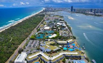 an aerial view of a large resort with multiple buildings , a beach , and a body of water at Sea World Resort