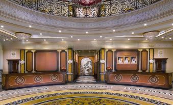 a grand foyer with a marble floor and ornate ceiling , featuring multiple steps leading up to the second floor at Royal Rose Abu Dhabi, a Curio Collection by Hilton Affiliated Hotel