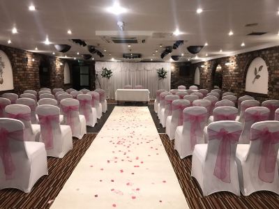 a wedding ceremony taking place in a room , with chairs set up for guests and decorations at Best Western Bradford Guide Post Hotel Best Western Bradford Guide Post Hotel Photo