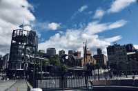 Sydney Opera House, Harbour Bridge, and clouds.