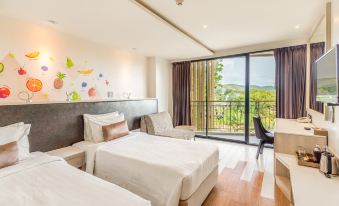 a hotel room with two beds , one on the left and one on the right side of the room at Sand Dunes Chaolao Beach Resort