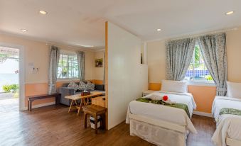 a hotel room with two beds , one on the left and one on the right side of the room at Pattaya Paradise Beach Resort