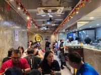 A restaurant serving hearty meals of porridge and Chinese barbecue