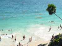 Ruins next to white sand beach 