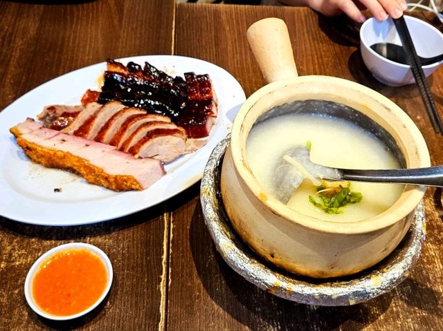 A restaurant serving hearty meals of porridge and Chinese barbecue