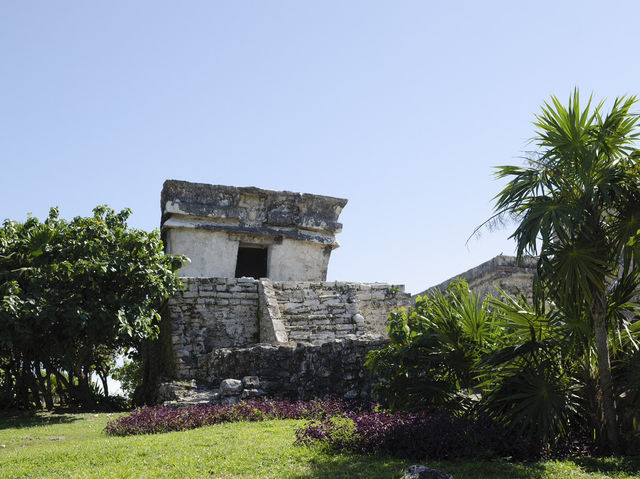 Ruins next to white sand beach 