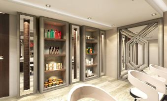 a modern bathroom with a large window and shelves filled with various toiletries and personal care items at Rizal Park Hotel