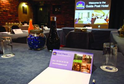 a hotel lobby with a dining table set for a meeting , where several people are discussing and drinking at Best Western Bradford Guide Post Hotel Best Western Bradford Guide Post Hotel Photo