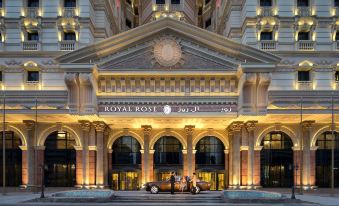 "a large , ornate building with a sign that reads "" royal rose hotel "" and a car parked outside" at Royal Rose Abu Dhabi, a Curio Collection by Hilton Affiliated Hotel