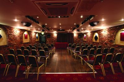 a well - lit auditorium with rows of chairs arranged in a symmetrical pattern , ready for a concert or event at Best Western Bradford Guide Post Hotel Best Western Bradford Guide Post Hotel Photo