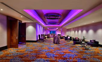 a large , well - lit conference room with multiple tables and chairs arranged for a meeting or event at Hyatt Regency Calgary