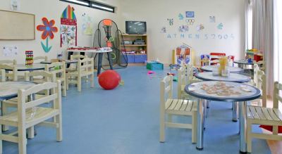 a brightly lit playroom with various toys and play equipment , including a basketball hoop and other toys at Ikos Dassia Ikos Dassia - All Inclusive Photo