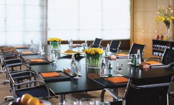 The meeting room features large windows and a long table surrounded by black chairs, accommodating up to 10 people at Four Seasons Damascus