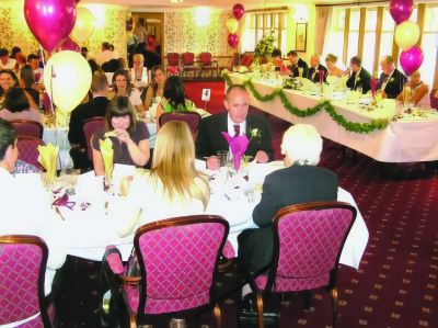 a group of people are sitting at tables in a room with balloons and chairs at Best Western Bradford Guide Post Hotel Best Western Bradford Guide Post Hotel Photo