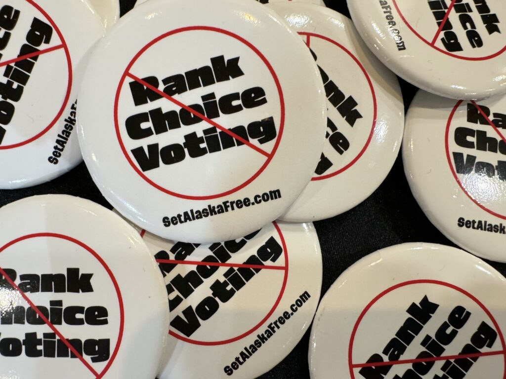 Pins supporting the repeal of ranked choice voting are seen on April 20, 2024, at the Republican state convention in Anchorage. (Photo by James Brooks/Alaska Beacon)