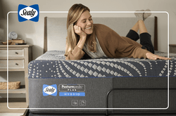 woman laying on a sealy mattress