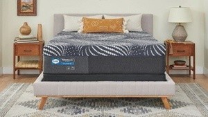 A posturepedic mattress in a styled room