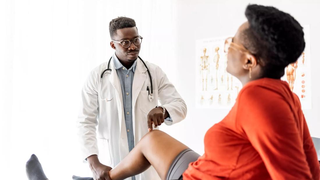 Healthcare provider checking patient's knee