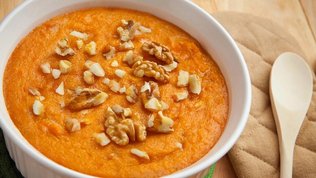 Ramekin of pumpkin pudding topped with walnuts