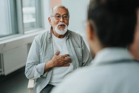 Person talking with healthcare provider in office