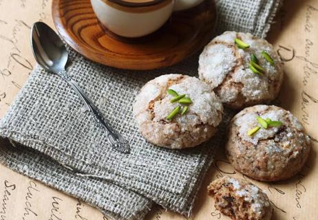 Sugar-coated gingerbread cookies on table, with cup of coffee and spoon