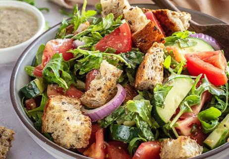 Bowl of Tuscan panzanella salad with croutons, red onion and tomatoes