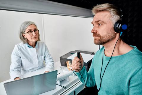 Person getting an audiogram, with technician