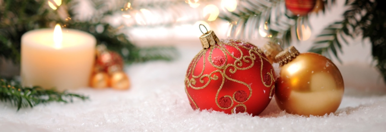 Candle with christmas balls and pine tree