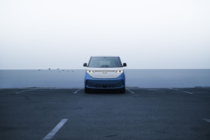 Head-on view of an ID. Buzz shown in Cabana Blue Metallic and Candy White parked in front of a blue and white two-tone wall.