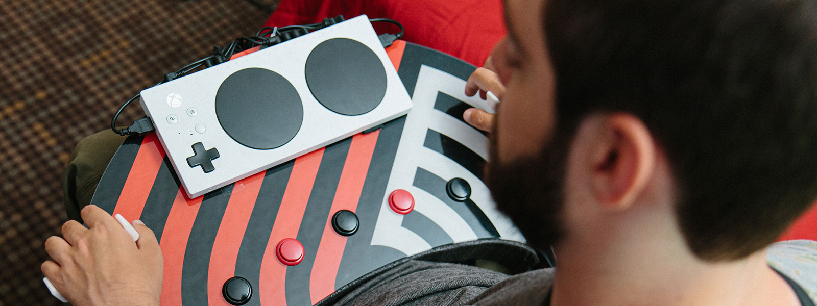 Spencer Allen with the Xbox Adaptive controller sitting on his custom built gaming controls