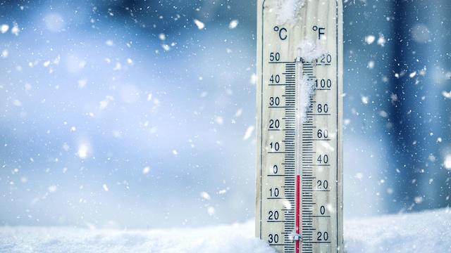 Thermometer on snow shows low temperatures - zero. Low temperatures in degrees Celsius and fahrenheit. Cold winter weather - zero celsius thirty two farenheit 