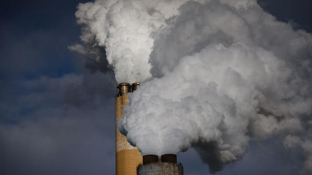 Steam billows out of the stacks at a coal-fired power plant 