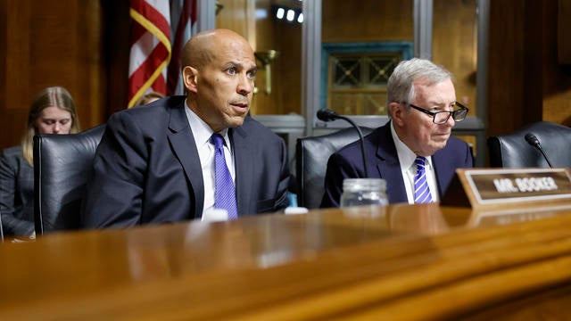 Sen. Cory Booker and Sen. Dick Durbin listen during a hearing with the Senate Judiciary subcommittee on Capitol Hill on June 12, 2024 in Washington, DC. 