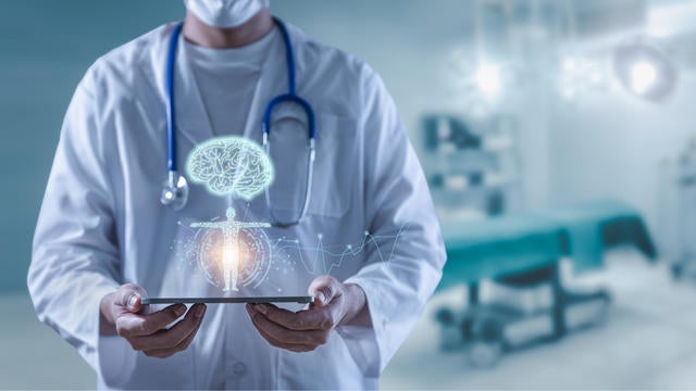 Doctor holding tablet showing brain human and body anatomy futuristic technology 