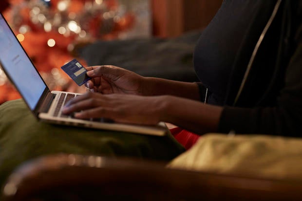 Young woman ordering Christmas gifts online 