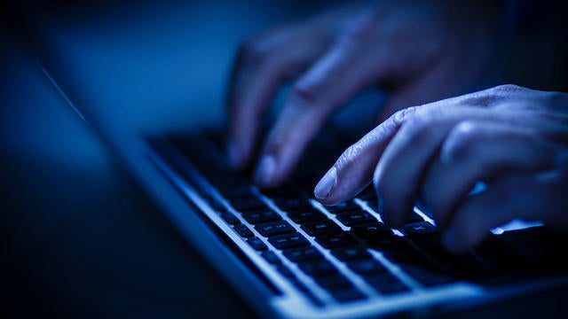 hands typing on a laptop computer 