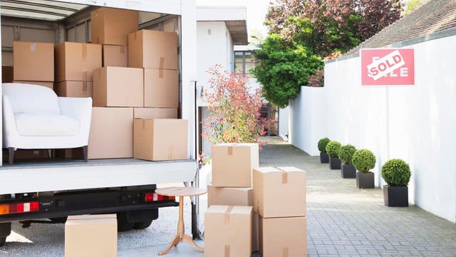 Boxes on ground near moving van 